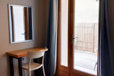 a table and a chair next to a window at La maison de Gaston au cœur du Luberon in Villars