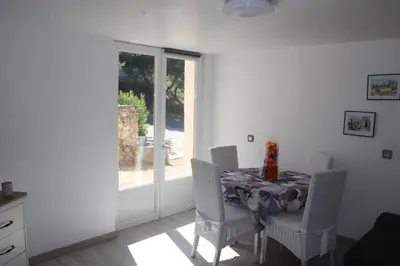 a dining room with a table and chairs and a window at les lauriers de Joelle in Peyrolles-en-Provence