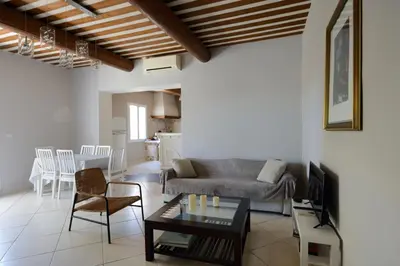 a living room with a couch and a table at La Petite Maison - Mas des Sous Bois in Ventabren