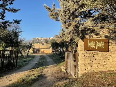 a sign that reads music properties next to a dirt road at l'Atelier des Milles Roches in Gordes