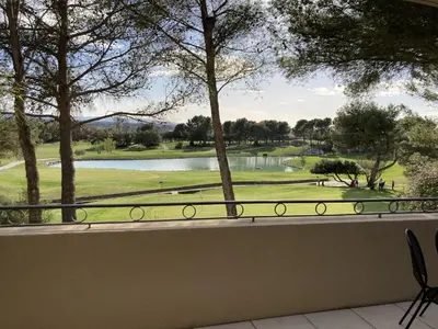 a view from a balcony of a golf course at LA PERLE DE PROVENCE-Magnifique Vue CLIM LINGE Golf Saumane 6P Piscine Tennis in Saumane-de-Vaucluse