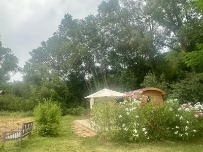 a bedroom with a large bed with two tables and two lamps at La Source in Rustrel