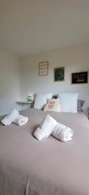 a large bed with two white towels on it at Villa la Provence, Luxe, Confort et Joie de Vivre in Carpentras
