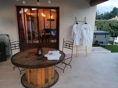 a table in a patio with a shirt hanging up at L'atelier de Guytou et Spa in Cheval-Blanc