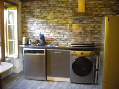 a kitchen with a stove and a sink and a dishwasher at Appartement à FONTAINE DE VAUCLUSE in Fontaine-de-Vaucluse