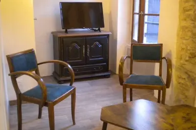 a living room with two chairs and a flat screen tv at Appartement à FONTAINE DE VAUCLUSE in Fontaine-de-Vaucluse