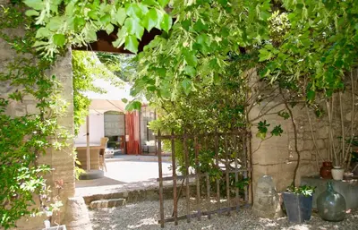 an entrance to a garden with a metal gate at LASUITE Domaine Bertuli, heated Pool, Aircon in Oppède