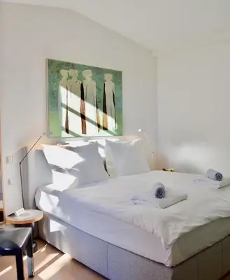 a bedroom with a large white bed with towels on it at LASUITE Domaine Bertuli, heated Pool, Aircon in Oppède