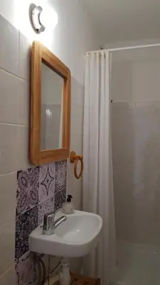 a bathroom with a sink and a shower with a mirror at Provence Luberon Goult Gite Mafasuza in Goult