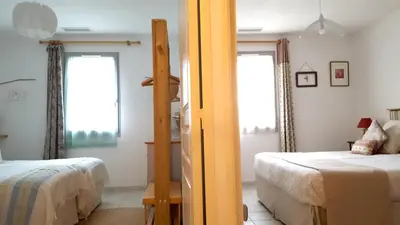 a bedroom with two beds and two windows at Provence Luberon Goult Gite Mafasuza in Goult