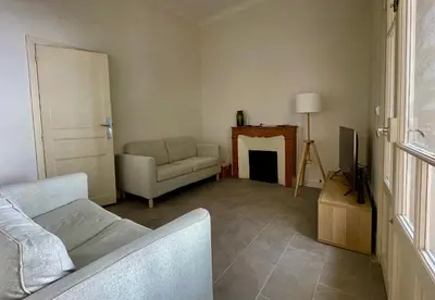 a living room with a couch and a fireplace at Maison & Jardin Coeur Luberon classé 4 étoiles in Peypin-dʼAigues