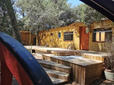 a log cabin with a deck and a house at Interlude in Lambesc