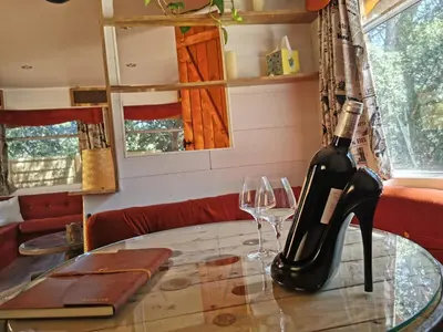 a bottle of wine sitting on a table with two glasses at Interlude in Lambesc