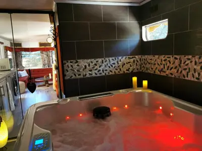 a bath tub with a dog in it with red lights at Interlude in Lambesc