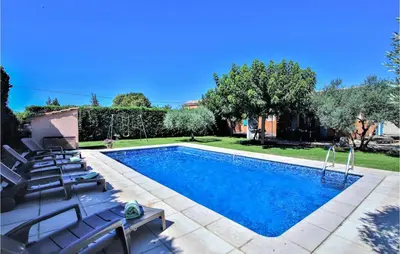 a swimming pool with lounge chairs around it at Cozy Home In Carpentras in Carpentras