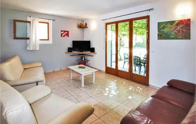 a living room with a couch and a table at Cozy Home In Carpentras in Carpentras