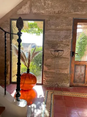 a vase sitting on a table in a room with a window at Villa Velleron - Bed and Breakfast in Velleron