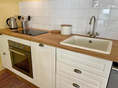 a kitchen with a sink and a counter top at Villa Velleron - Bed and Breakfast in Velleron