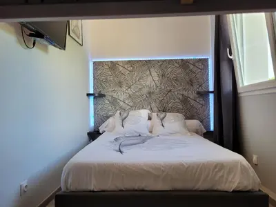 a bed in a room with a wall at Les Prairies de l'Encrême in Céreste