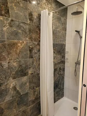 a bathroom with a shower with a shower curtain at Les Prairies de l'Encrême in Céreste