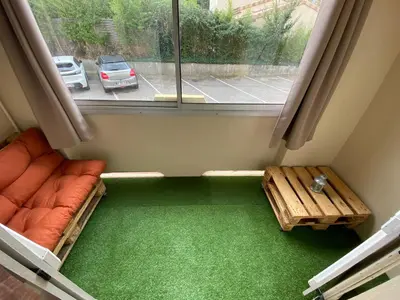 a room with a window with a couch and a table at Appartement T2 Cosy sur Aix in Aix-en-Provence