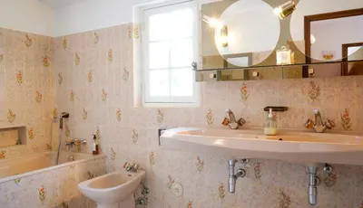 a bathroom with a sink and a mirror and a tub at Chambres dans le Luberon - Bois Romay in La Bastide-des-Jourdans