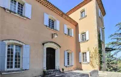 a large house with a black door and windows at 7 Bedroom Nice Home In Apt in Apt