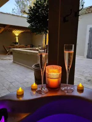 two glasses of champagne sitting on a table at Le Cabanon de Nans. Gîte de charme en Provence. in Grans