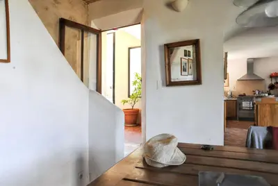 a room with a staircase and a living room at Villa élégante avec piscine privée à Ansouis, vues montagne in Ansouis