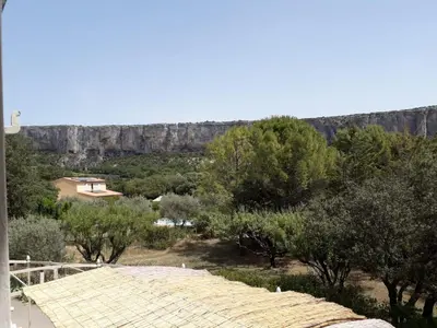 a view of a mountain with trees and a building at MAISON BOURGUES in Lioux