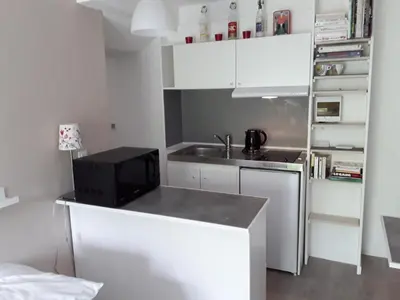 a small kitchen with a sink and a microwave at Studio avec kitchenette du sentier des ocres in Roussillon