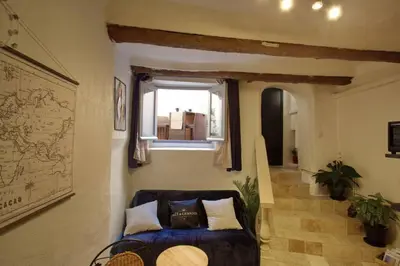 a living room with a couch and a window at Les Secrets d'Alcôve, nuits Romantiques avec SPA in Aix-en-Provence