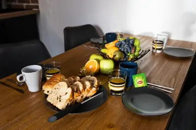 a table with a plate of bread and fruit on it at OPEN SKY Industry Hyper Centre Fontaine Moussue in Salon-de-Provence