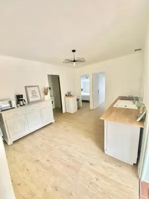 an empty living room with a counter and a kitchen at Il y a le Soleil, la Campagne et la Mer in Martigues