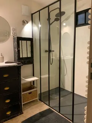 a bathroom with a shower with a glass door at Au petit bonheur in LʼIsle-sur-la-Sorgue