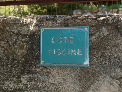 a sign on a stone wall that reads coffeeitance at jardin d'antan in Ansouis