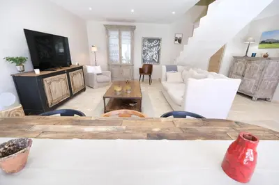 a living room with a table and a couch at charming house with private pool in the heart of the village of aureille in the alpilles, 6 people. in Aureille