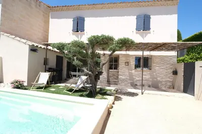 a villa with a swimming pool and a house at charming house with private pool in the heart of the village of aureille in the alpilles, 6 people. in Aureille