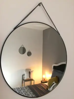 a mirror reflecting a bedroom with a bed at Chambre d'hôte Mas de Silvacane in La Roque-dʼAnthéron