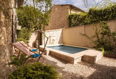 a swimming pool in the backyard of a house at Le Mas des Sablières in Oppède