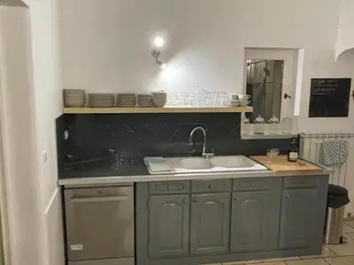 a kitchen with a sink and a mirror at Villa Abayers in Apt