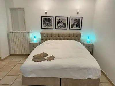 a bedroom with a white bed with two towels on it at Villa Abayers in Apt