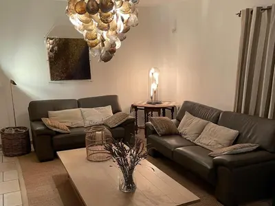 a living room with two couches and a table at Grands Abayers in Apt