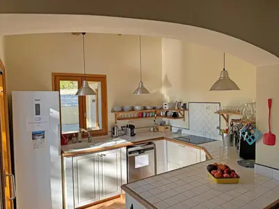 a kitchen with a bowl of fruit on a counter at Villa Bellegarde in Saignon