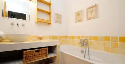 a bathroom with a sink and a bath tub at Domaine Faverot in Maubec