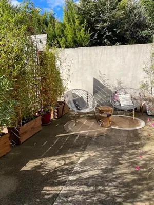 three chairs and a table in a garden at Mas de la Butte Blanche in Orgon