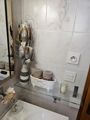 a bathroom with a glass shelf with a sink and a mirror at Au pied du Massif des Costes in Pélissanne