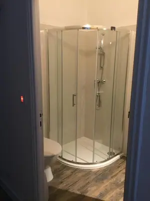 a glass shower in a bathroom with a toilet at Petit cocon dans le Luberon in Lauris
