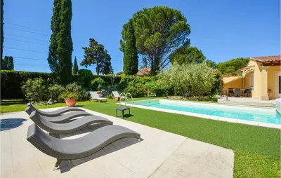 a swimming pool with three benches in a yard at Cozy Home In Cabannes With Wifi in Cabannes