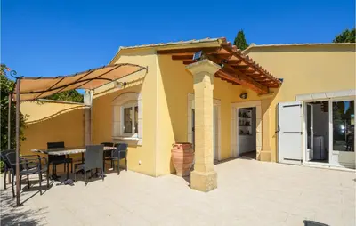 a patio with a table and chairs and a house at Cozy Home In Cabannes With Wifi in Cabannes